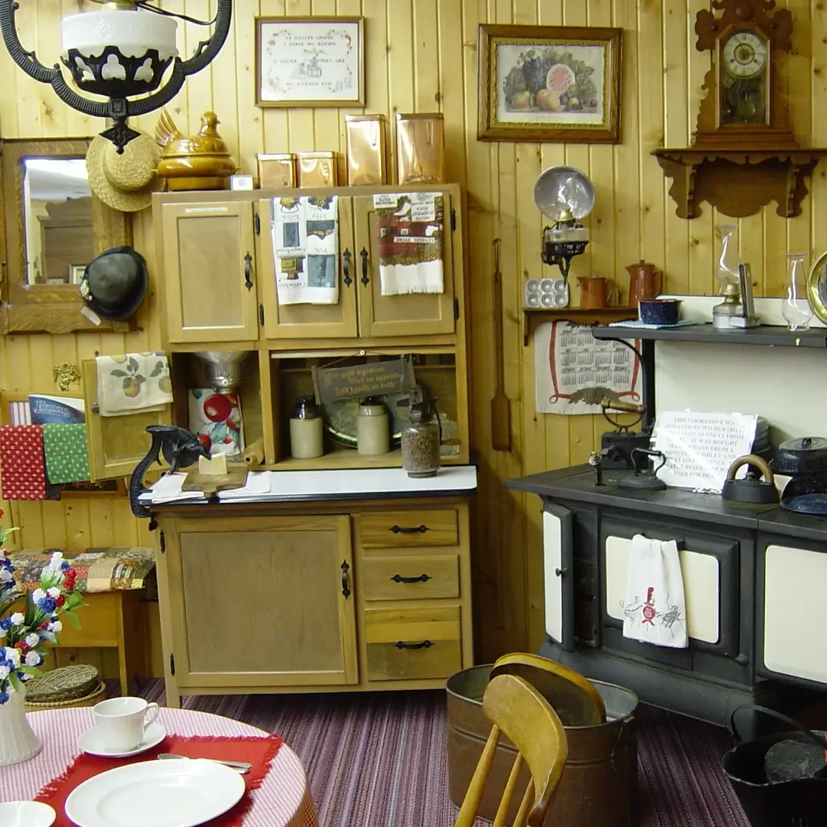 Dorothea Brunson’s dining room at McCallum Museum Brunson Heritage House in Sibley, Iowa featuring her beloved cranberry glassware collection and Petit Point needlework