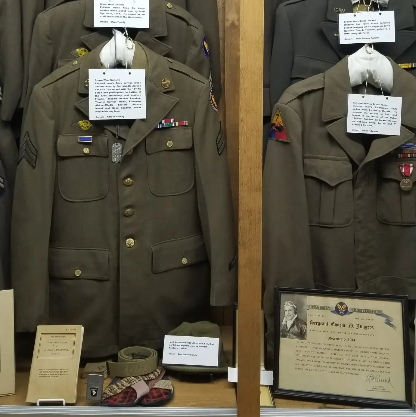 WWII military uniforms and medals display at McCallum Museum in Sibley, Iowa honoring local Osceola County veterans including Sgt. Maude Adreon and Sgt. Eugene D. Jungers